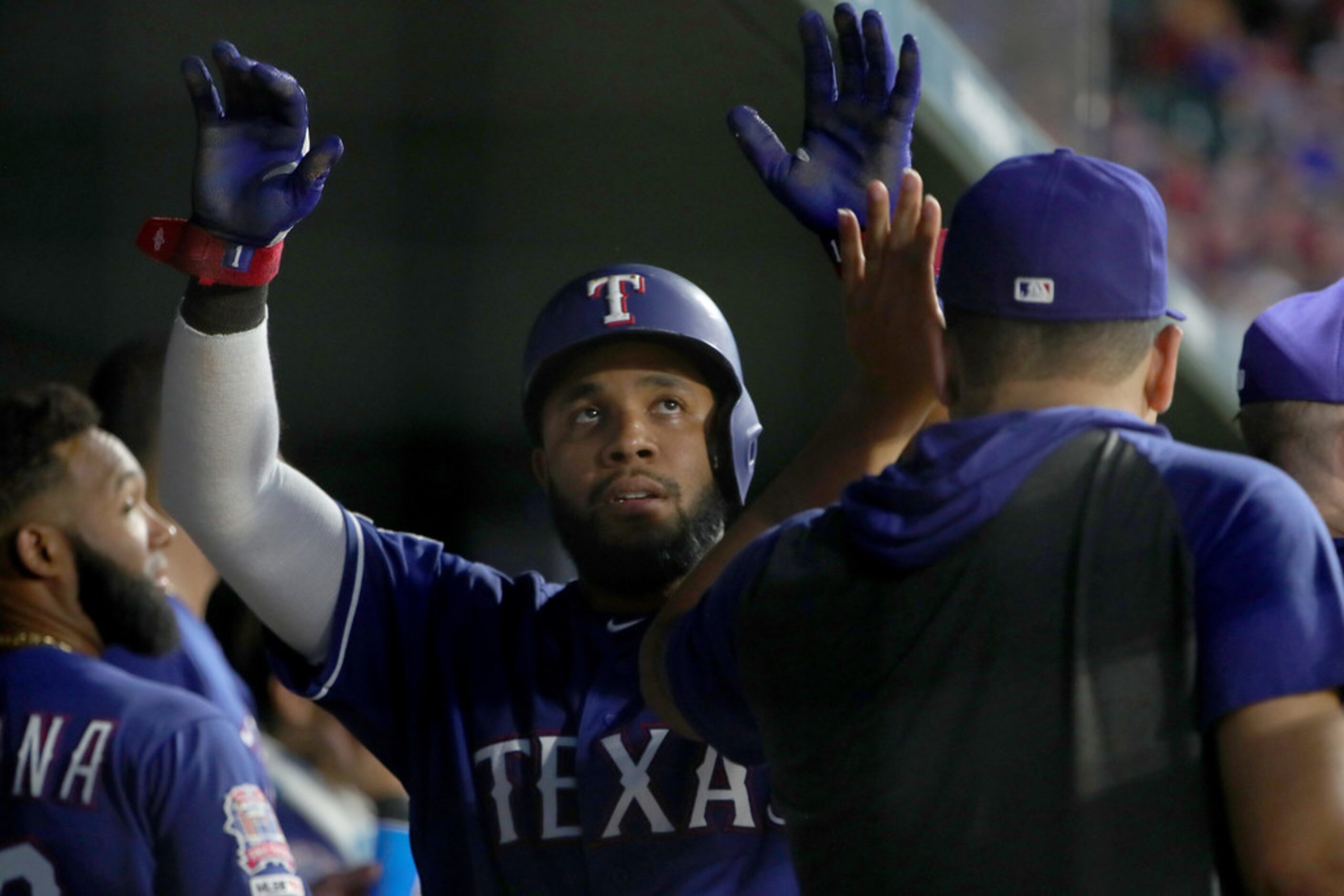 ARLINGTON, TEXAS - AUGUST 16: Elvis Andrus #1 of the Texas Rangers celebrates after scoring...