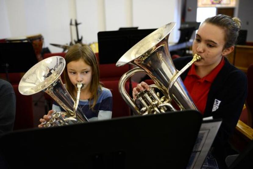 Band students Ellie Howard (left), 9, and Rebecca Hood 239  play their instruments at the...