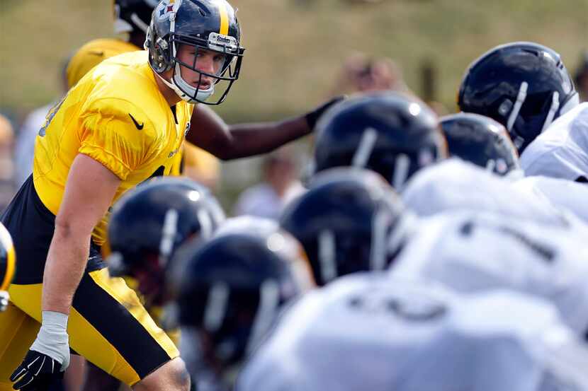 Pittsburgh Steelers linebacker T.J. Watt, left, lines up in drills during NFL football...