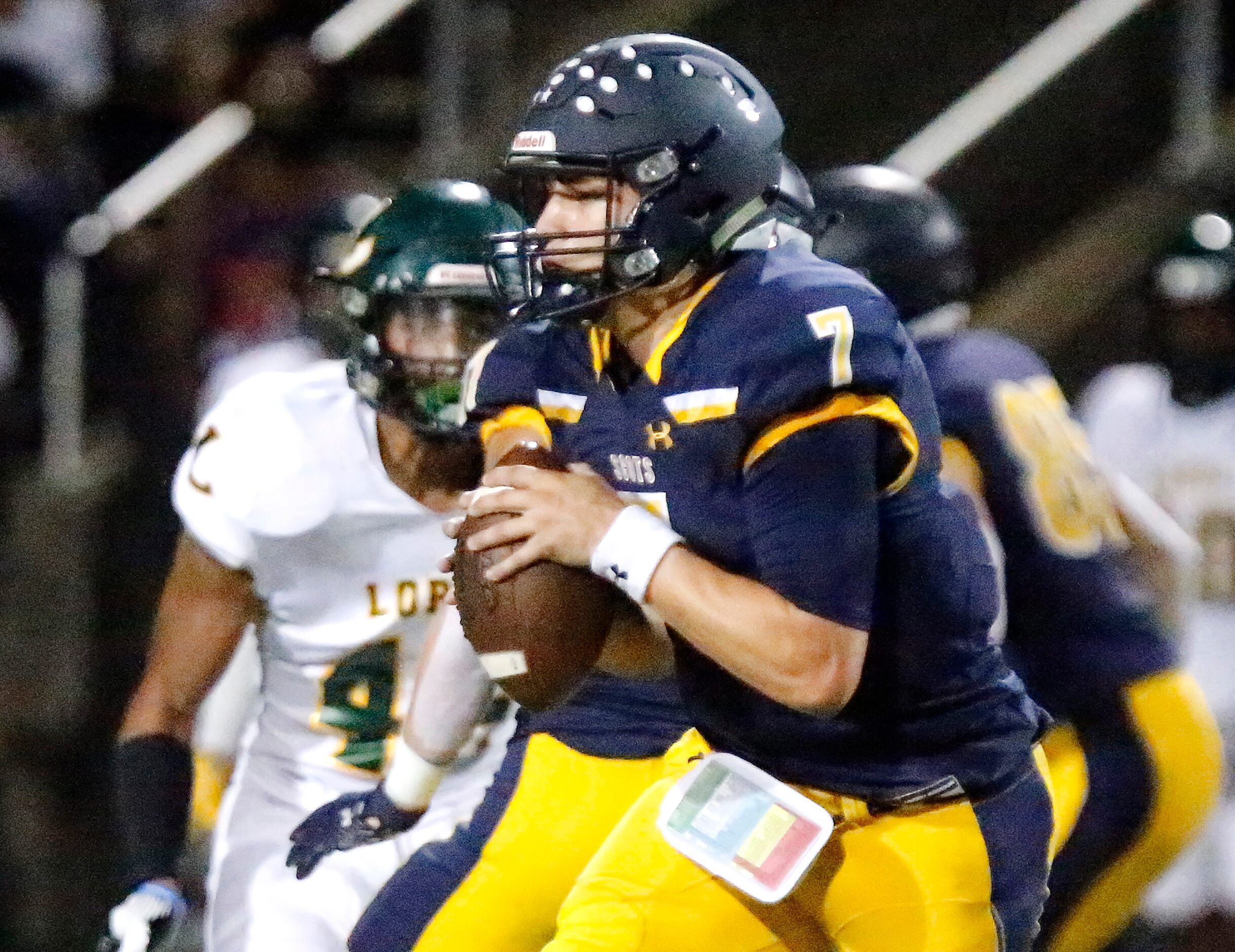 Highland Park High School quarterback Brennan Storer (7) prepares to throw a pass during the...