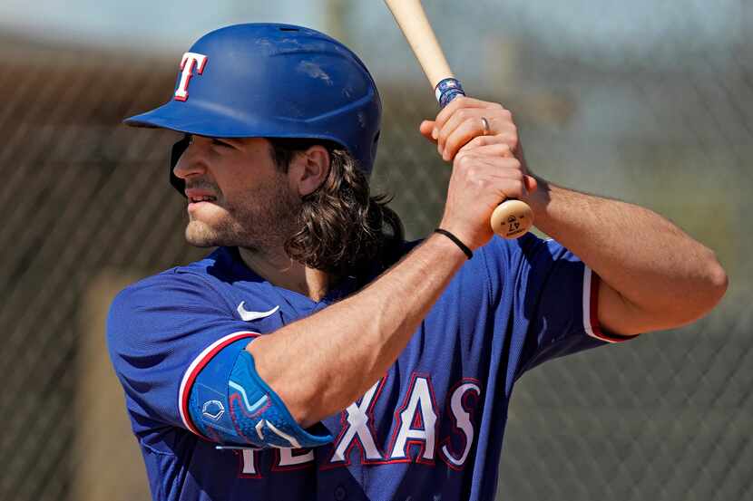 Texas Rangers' Josh Smith bats during spring training baseball practice Monday, Feb. 20,...