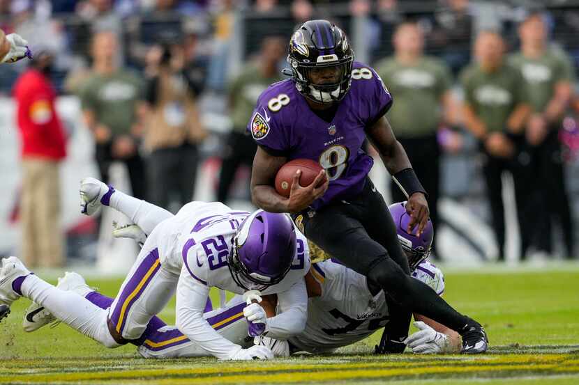 Baltimore Ravens quarterback Lamar Jackson (8) is tackled by Minnesota Vikings defensive...