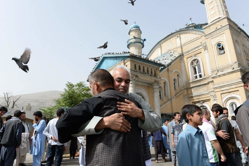 Afghan Muslims hugged each other in June after offering prayers at the start of the Eid...