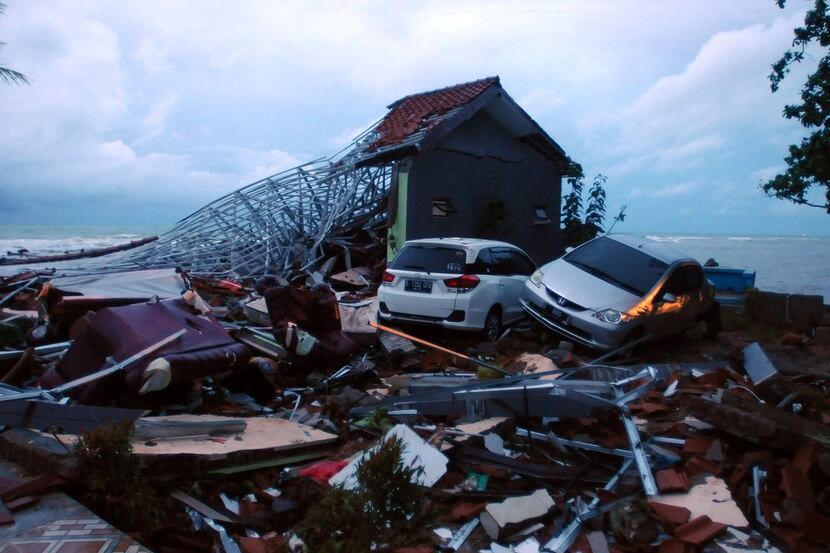 Debris from damaged buildings and cars are seen near the beach in Anyer, Serang on December...