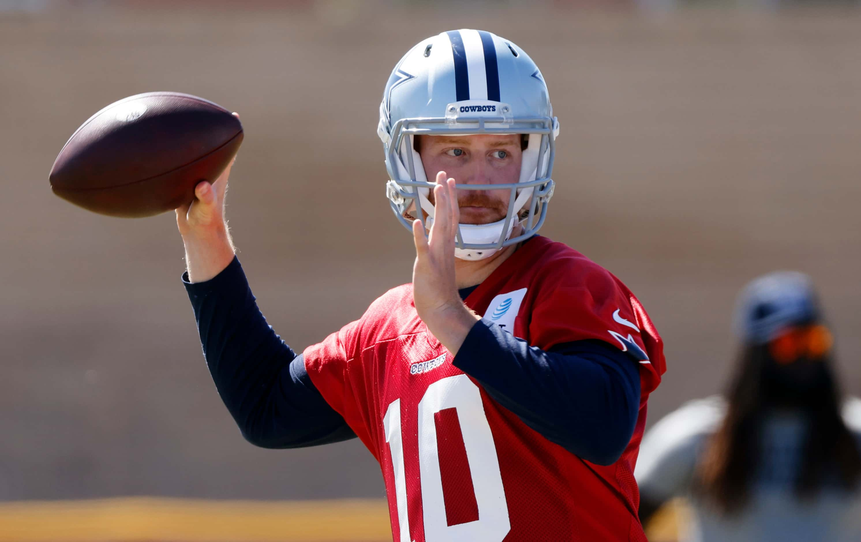 Dallas Cowboys quarterback Cooper Rush (10) throws during a walk-thru at training camp in...