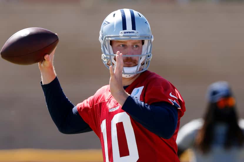 Dallas Cowboys quarterback Cooper Rush (10) throws during a walk-thru at training camp in...