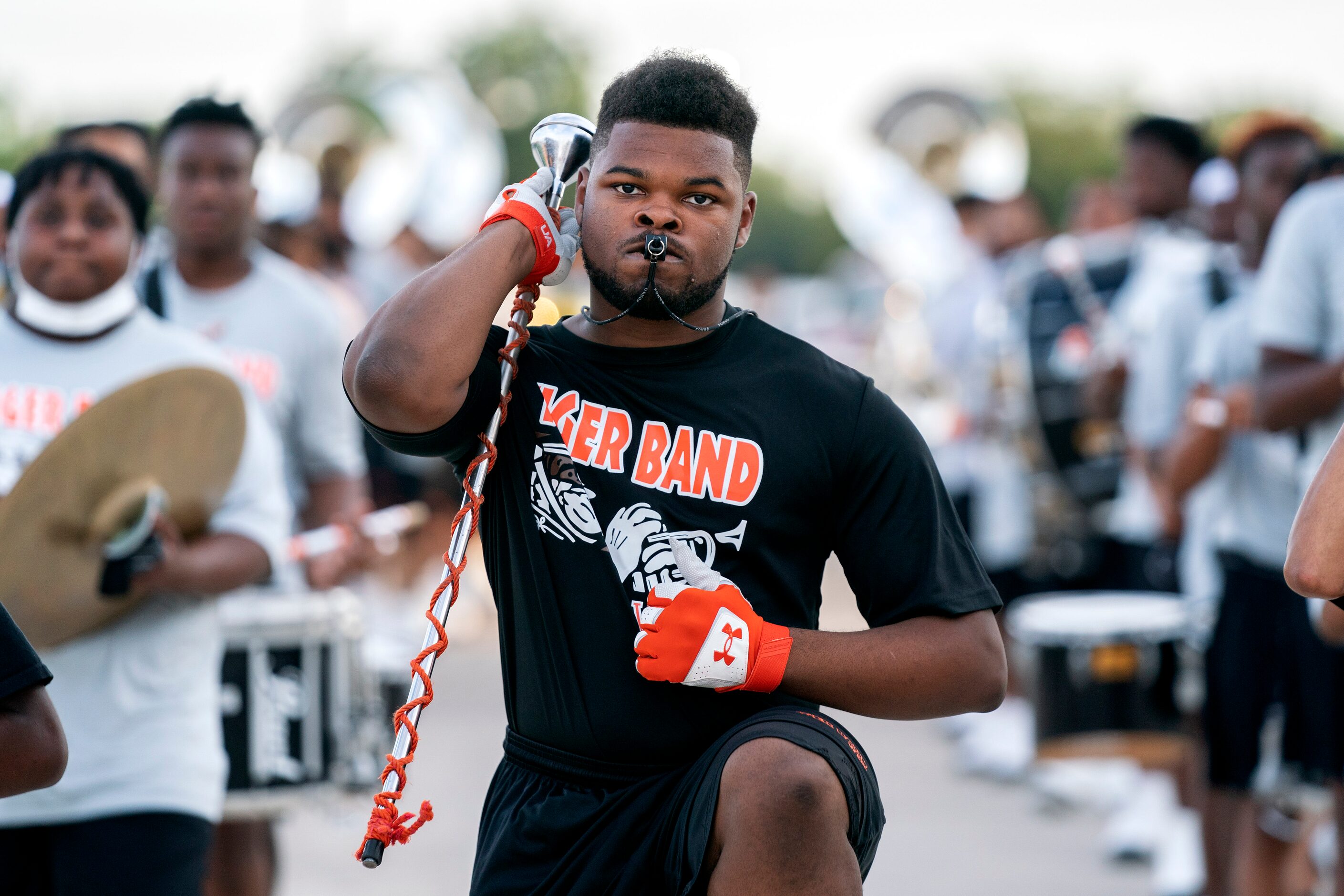 Lancaster head drum major Kamori Bougere leads the band into the stadium before a high...