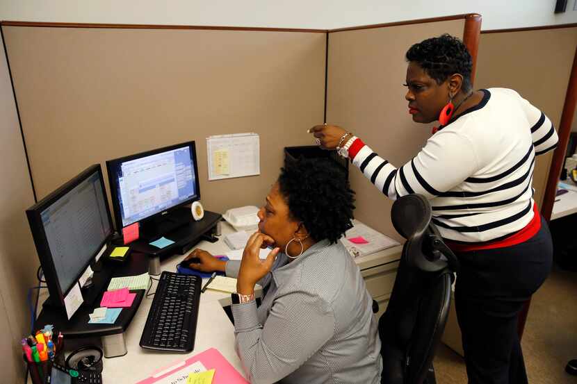 Tangela Matthews (left) and Yolanda Morris work in the central scheduling office at...