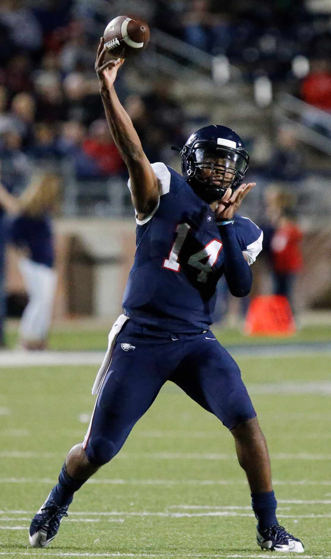 Allen High School quarterback Grant Tisdale (14) throws a pass during the first half as...