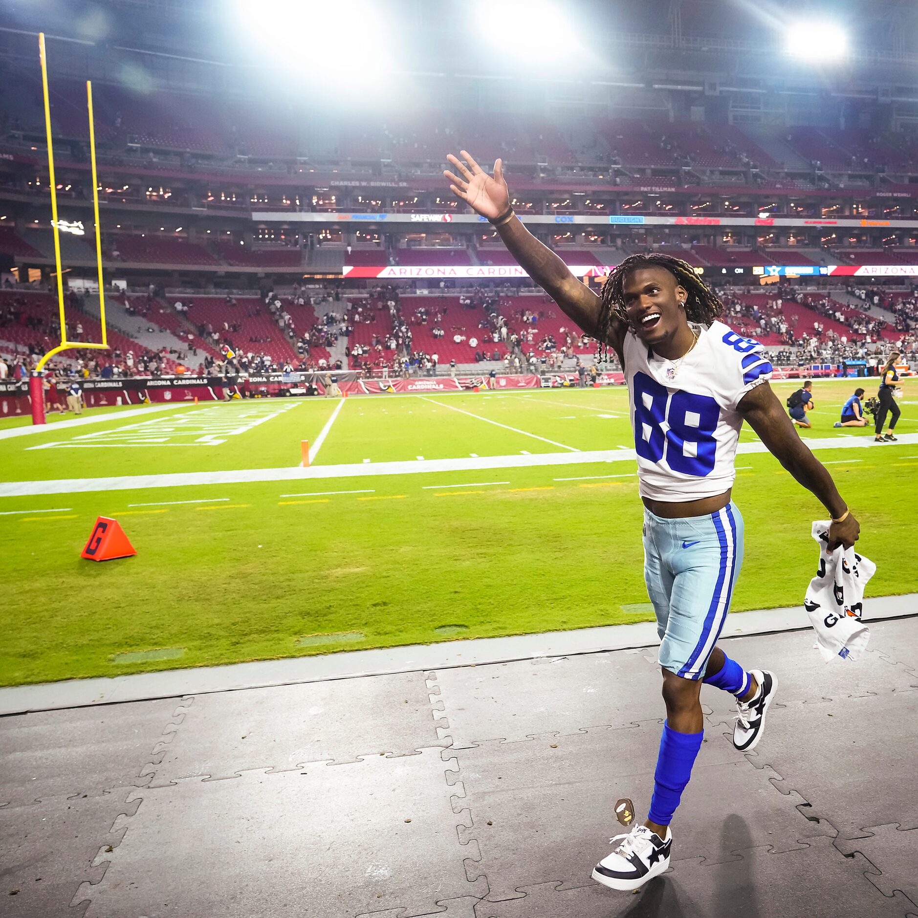 Dallas Cowboys wide receiver CeeDee Lamb waves to fans as he leaves the field after during a...