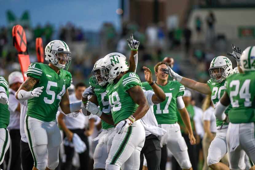 Players celebrate after North Texas linebacker Jamie King (48) recovered a fumble during the...