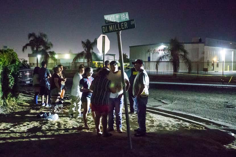 A crowd gathers near a location where a gunman opened fire, killing several people,...