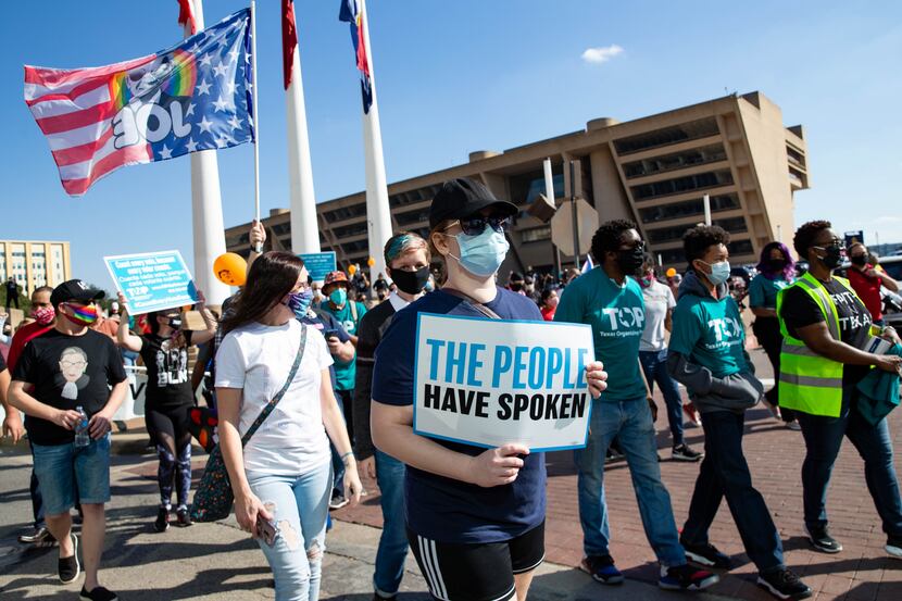 Demonstrators march following a Count Every Vote rally in downtown Dallas on Saturday, Nov....