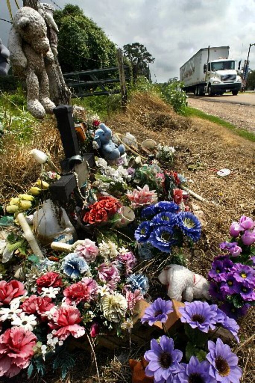 Flowers, teddy bears, water and rosary beads are among the items left in 2004 at the site...