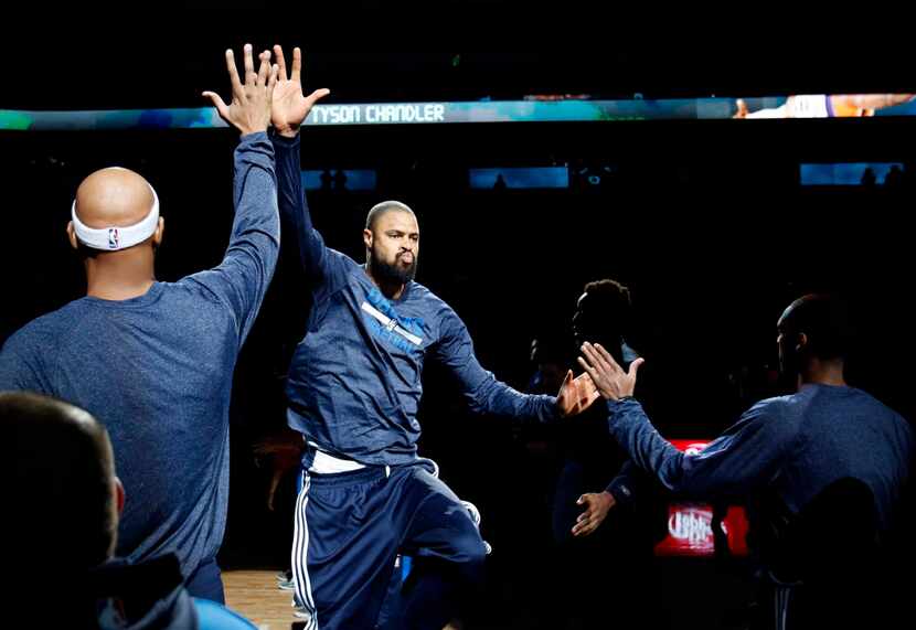 Dallas Mavericks center Tyson Chandler (6) slaps hands with Dallas Mavericks forward Charlie...