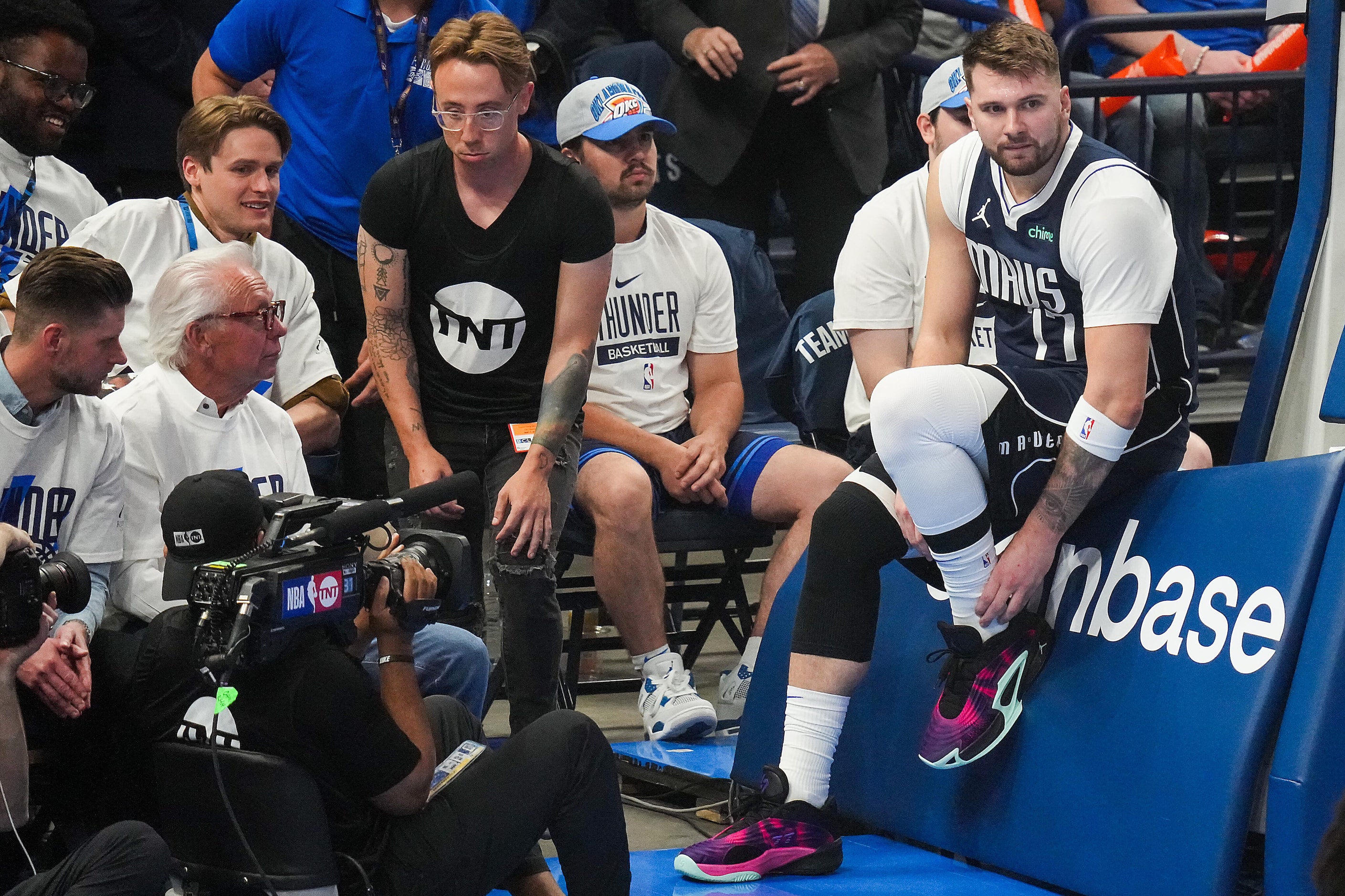 Dallas Mavericks guard Luka Doncic (77) is grabs his left lower leg after a play during the...