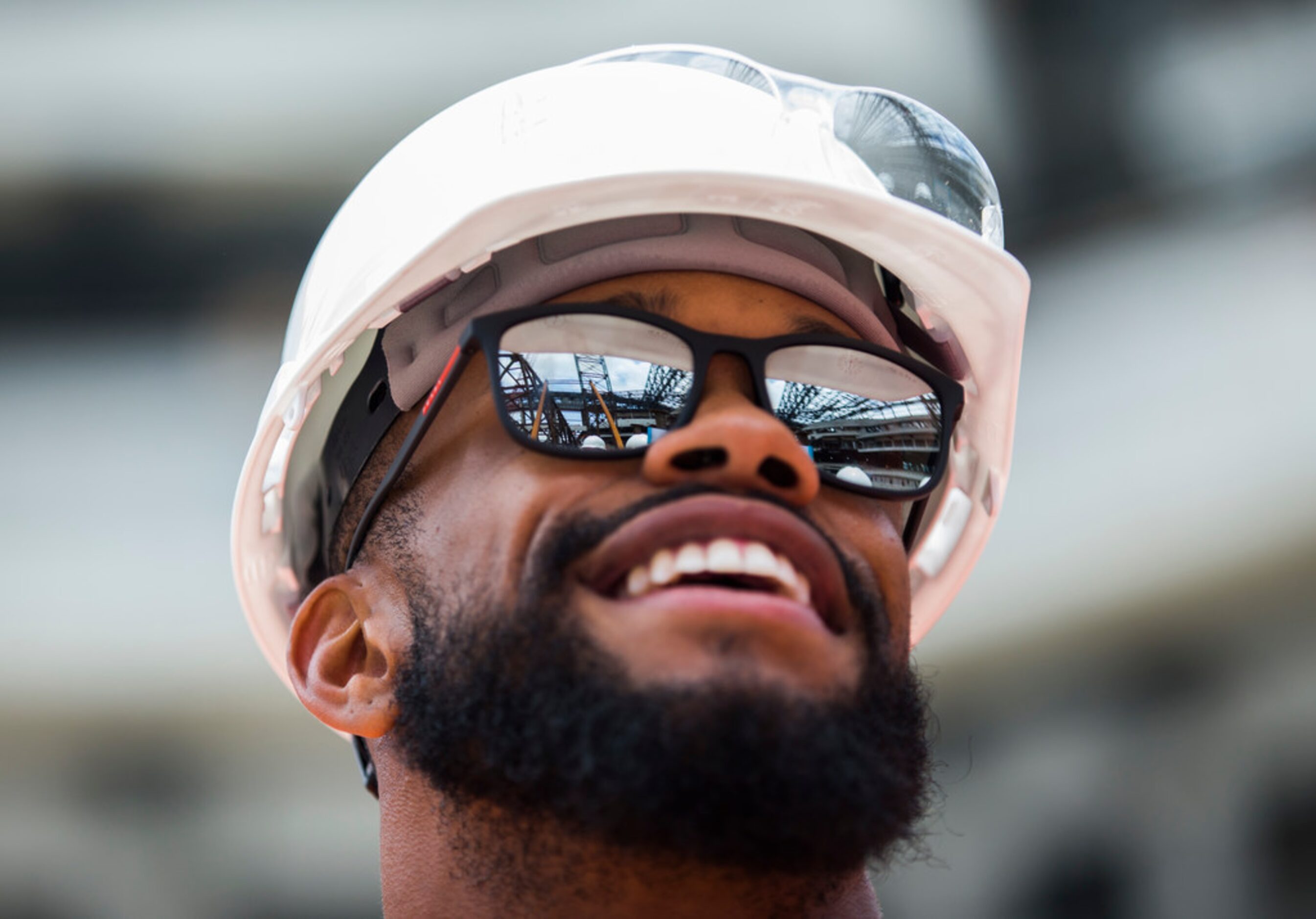 Texas Rangers center fielder Delino DeShields smiles as he stands on the field and looks up...