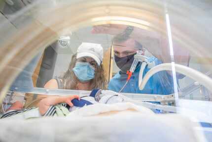 Katie and Chris Sturm view one of the quadruplets in the neonatal intensive care unit....