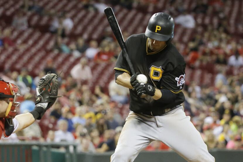 Pittsburgh Pirates' David Freese is hit by a pitch from Cincinnati Reds reliever Ross...