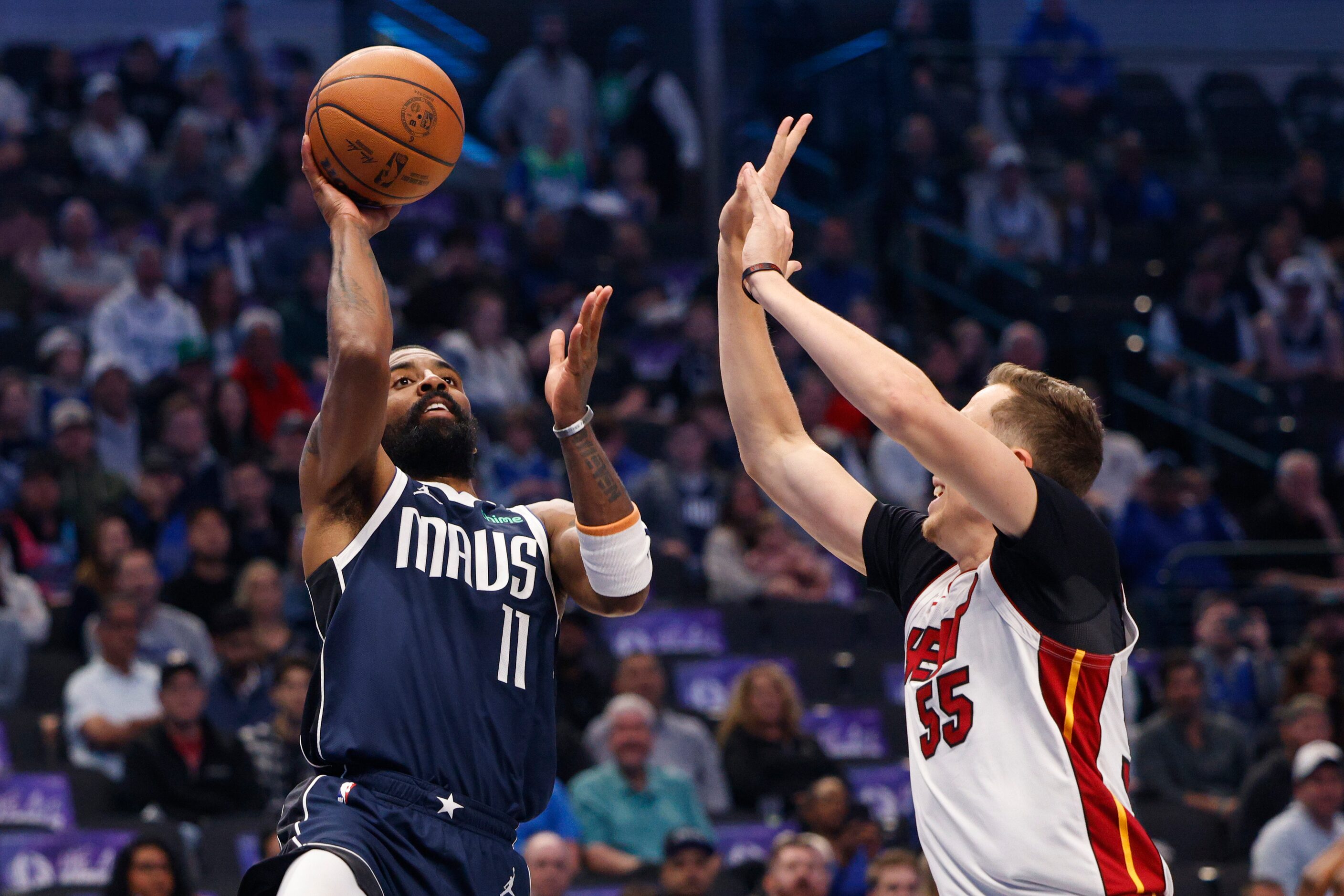 Dallas Mavericks guard Kyrie Irving (11) floats a shot over Miami Heat forward Duncan...