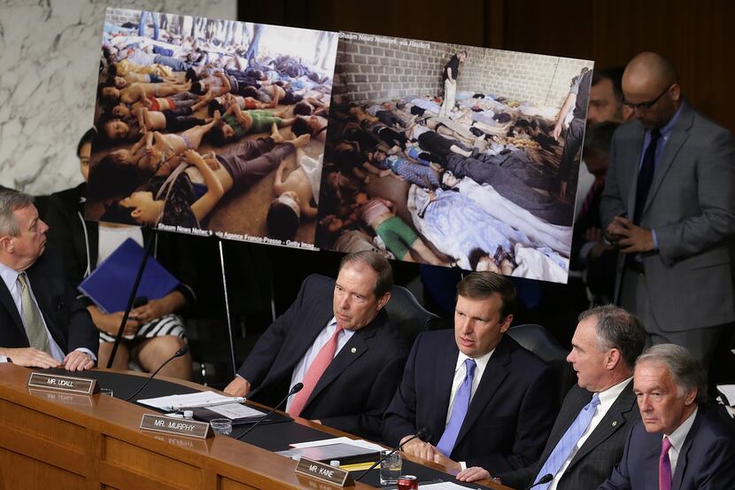 U.S. Senators view photographs of victims of chemical weapons attacks in Syria as U.S....