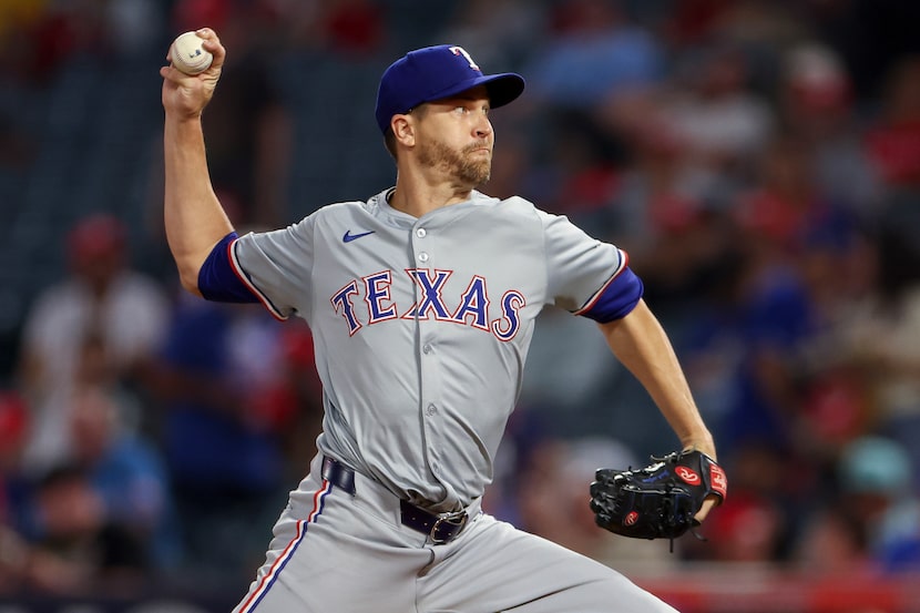 Texas Rangers starting pitcher Jacob deGrom throws during the first inning of a baseball...