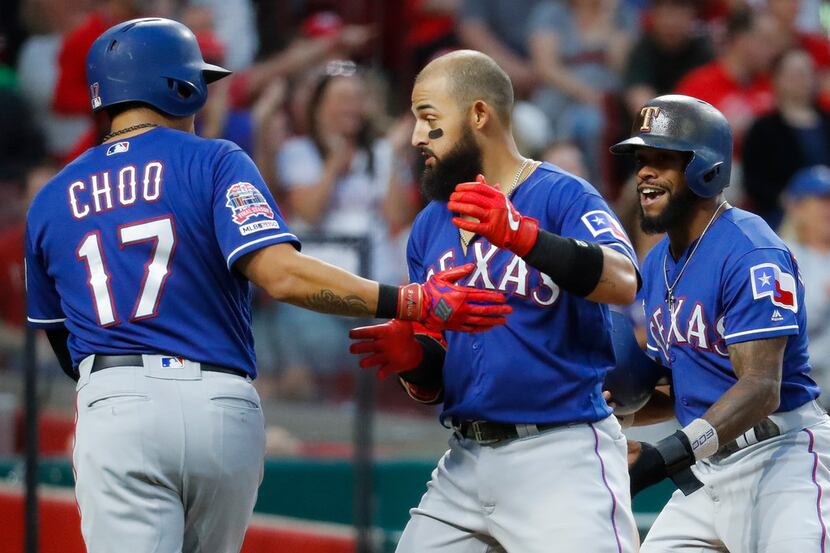 Texas Rangers' Rougned Odor, center, celebrates with Shin-Soo Choo (17) after hitting a...