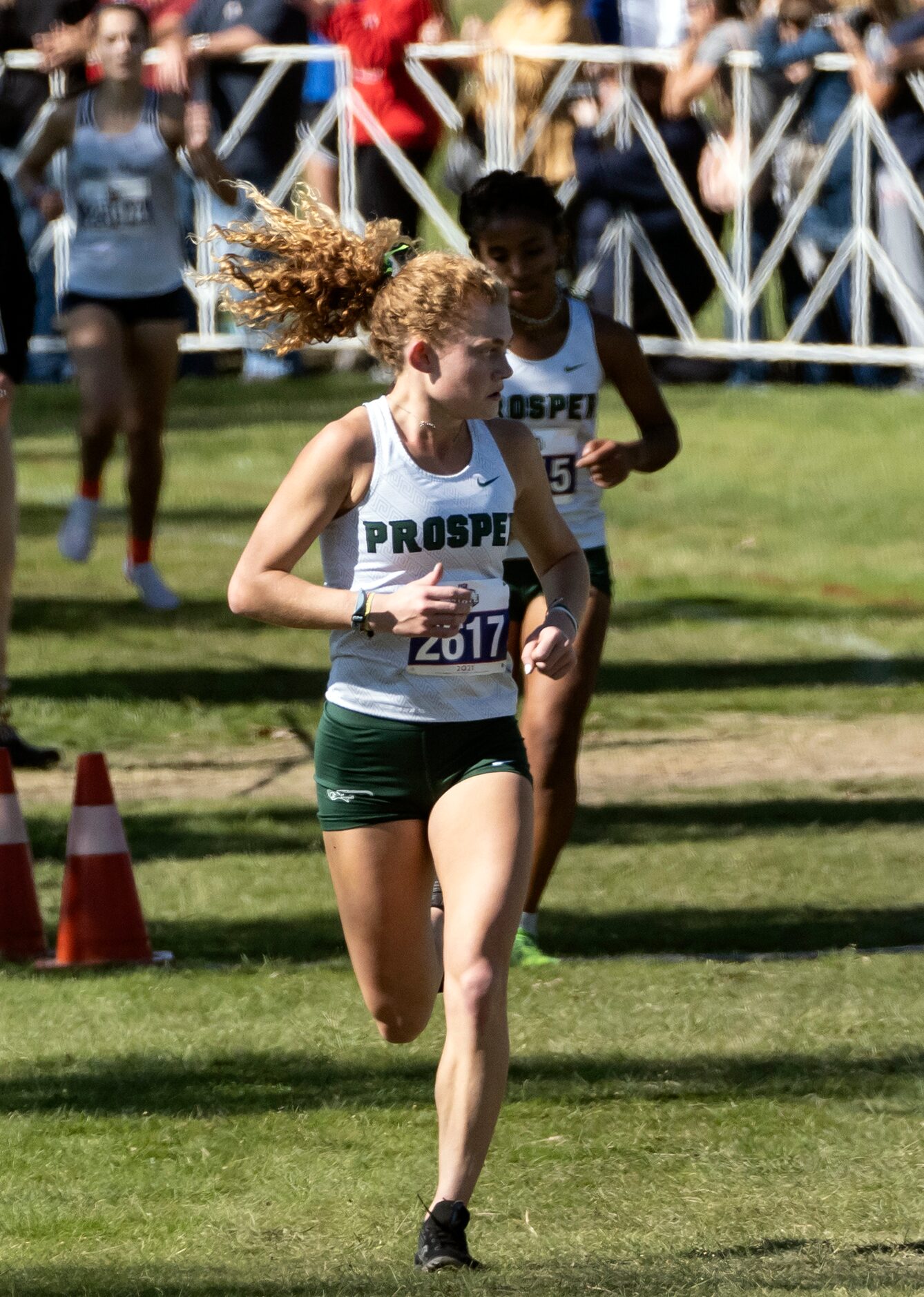 Prosper Aubrey OÕConnell, heading for second place finish, (2617) looks over her shoulder as...