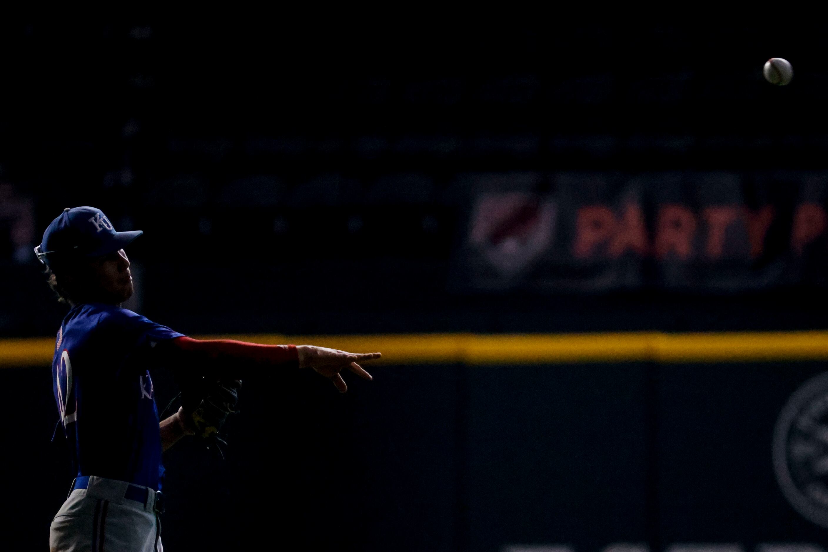 Kansas outfielder Chase Jans warms up during the first inning of a baseball game against...