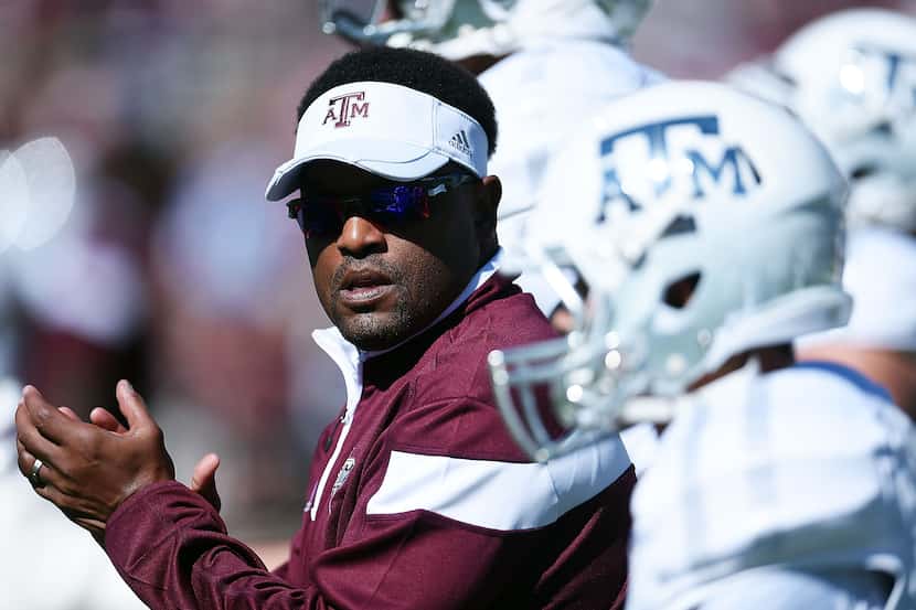 Head coach Kevin Sumlin of the Texas A&M Aggies leads his team onto the field prior to a...