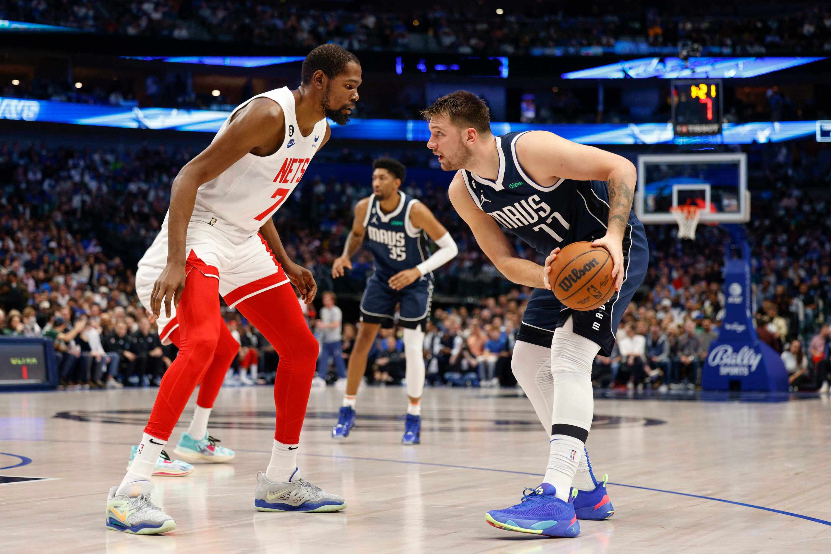 Brooklyn Nets forward Kevin Durant (7) defends against Dallas Mavericks guard Luka Doncic...