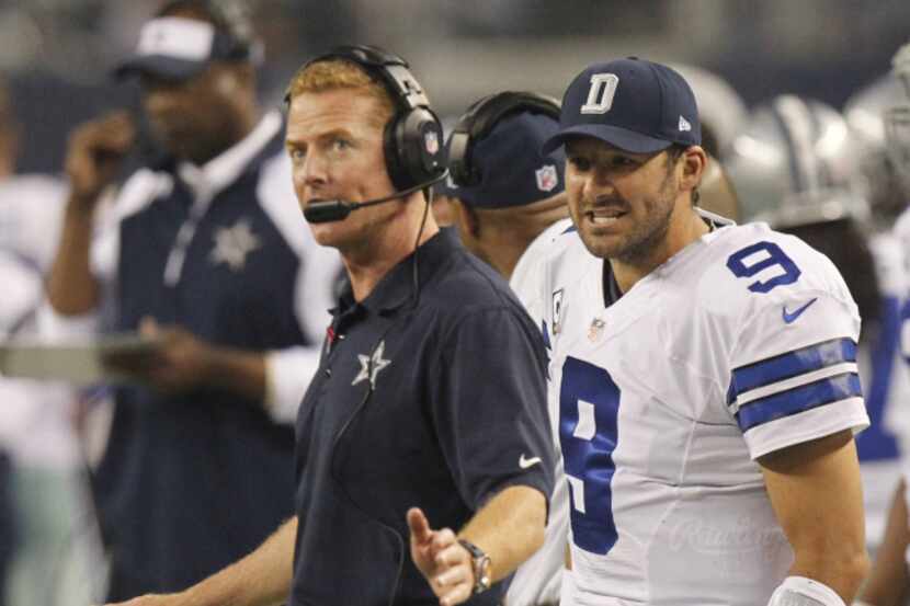 Dallas Cowboys head coach Jason Garrett gets some words from Dallas Cowboys quarterback Tony...