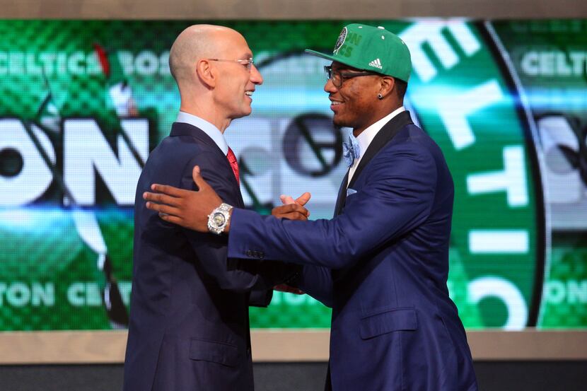Jun 26, 2014; Brooklyn, NY, USA; Marcus Smart (Oklahoma State) shakes hands with NBA...