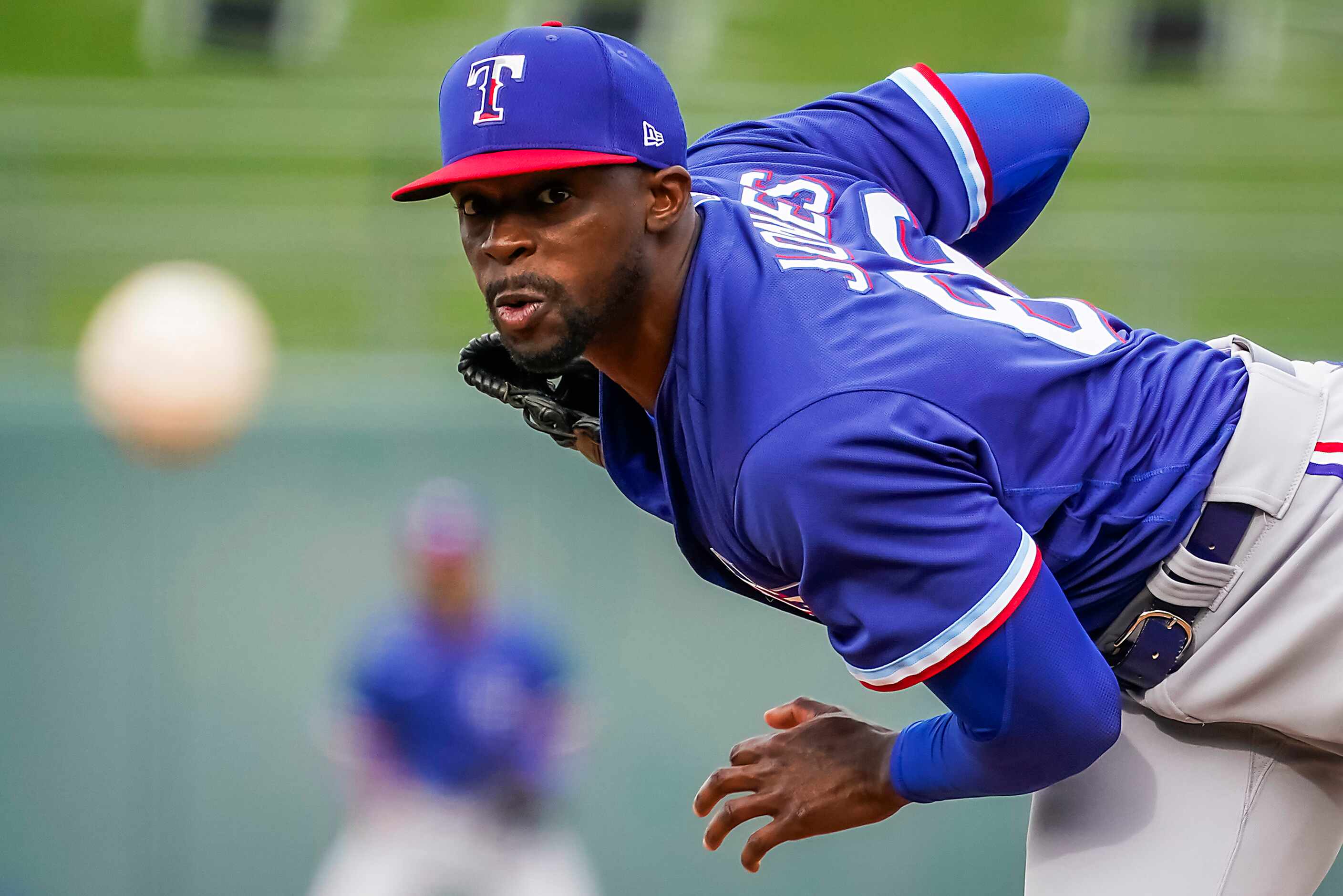 Texas Rangers pitcher James Jones pitches during the ninth inning of a spring training game...