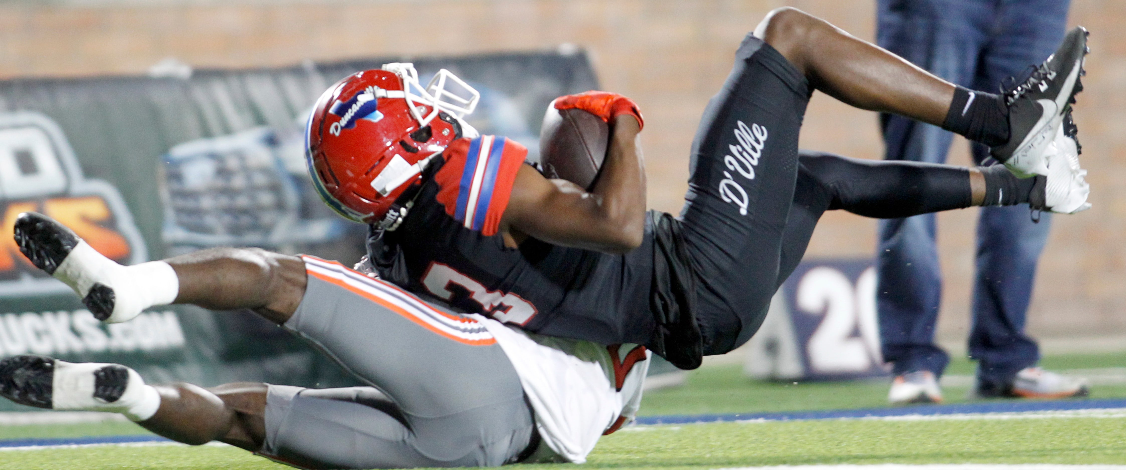 Duncanville receiver Emmanuel Ellison (13), top, pulls in a long pass over the defense of...