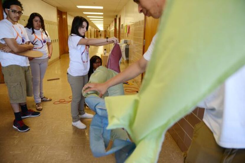 
Students work on their Destination Imagination team's anti-smoking campaign at Bryan Adams...