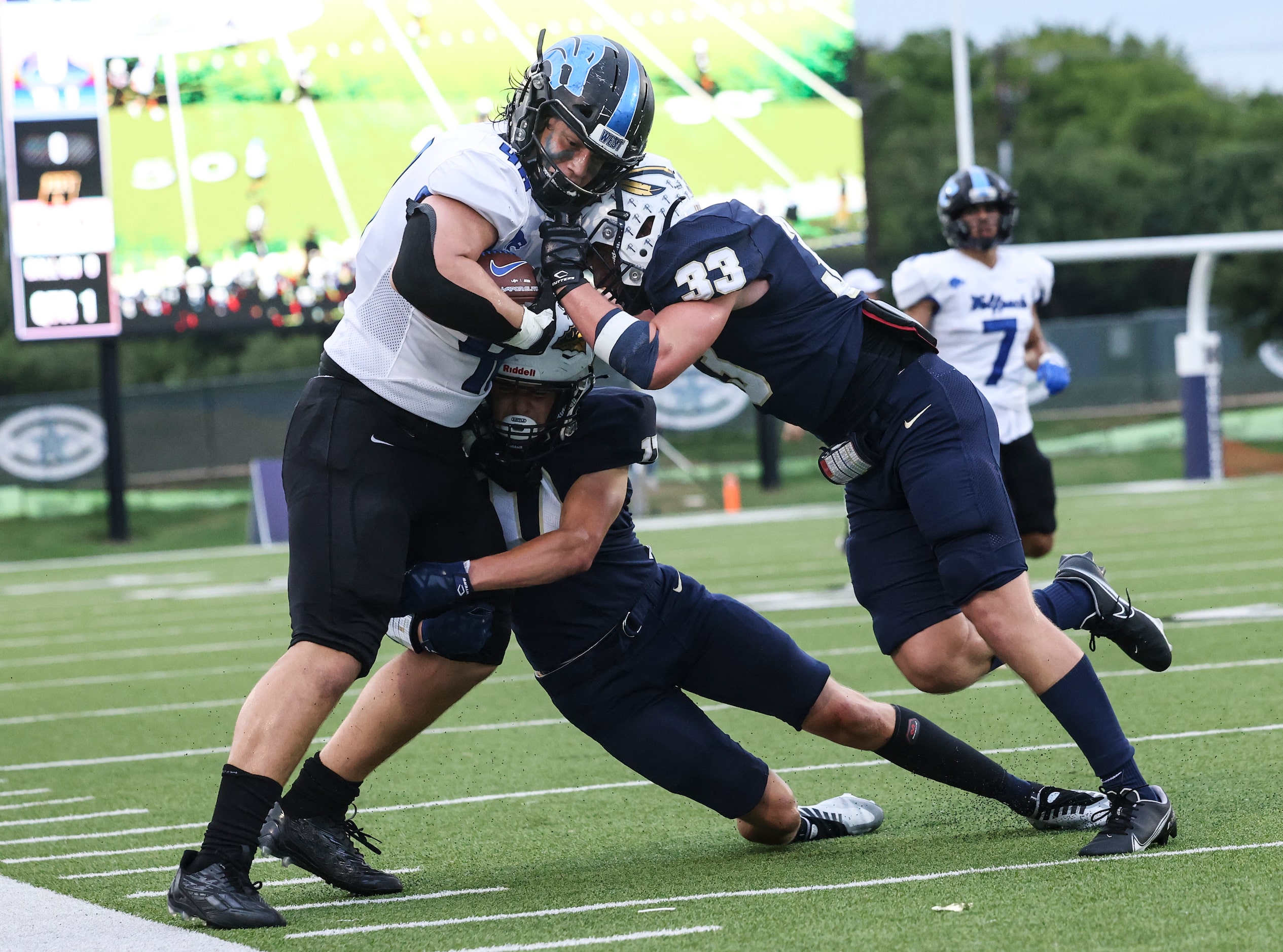 Keller High School Amarion Henry (11) and Treyce Peck (33) push Plano West Senior High Lucas...