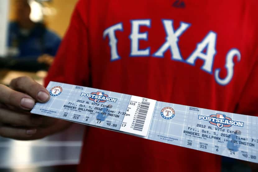Texas Rangers fan Jeremiah Franklin of Arlington shows off his upper reserved tickets after...