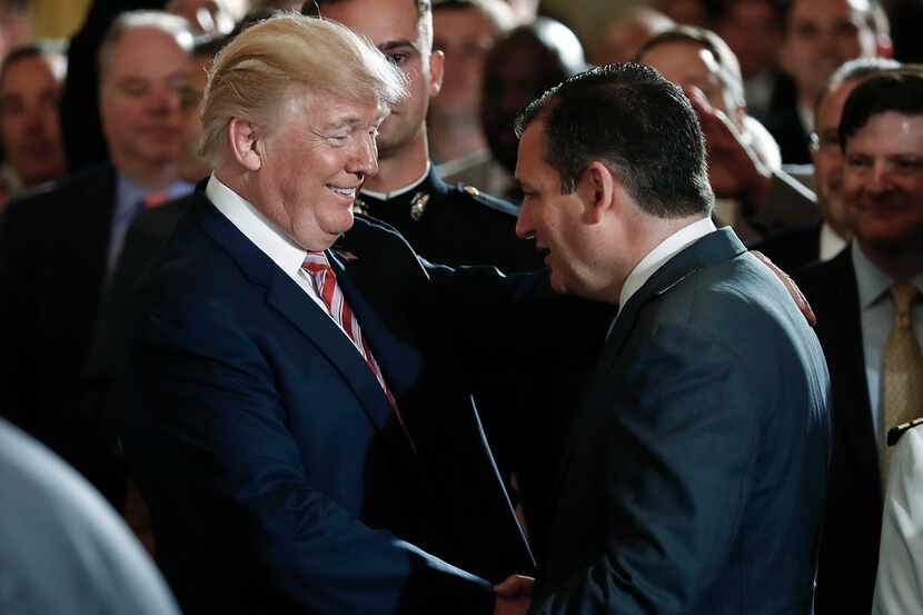President Donald Trump shakes hands with Sen. Ted Cruz, R-Texas, in the East Room at the...
