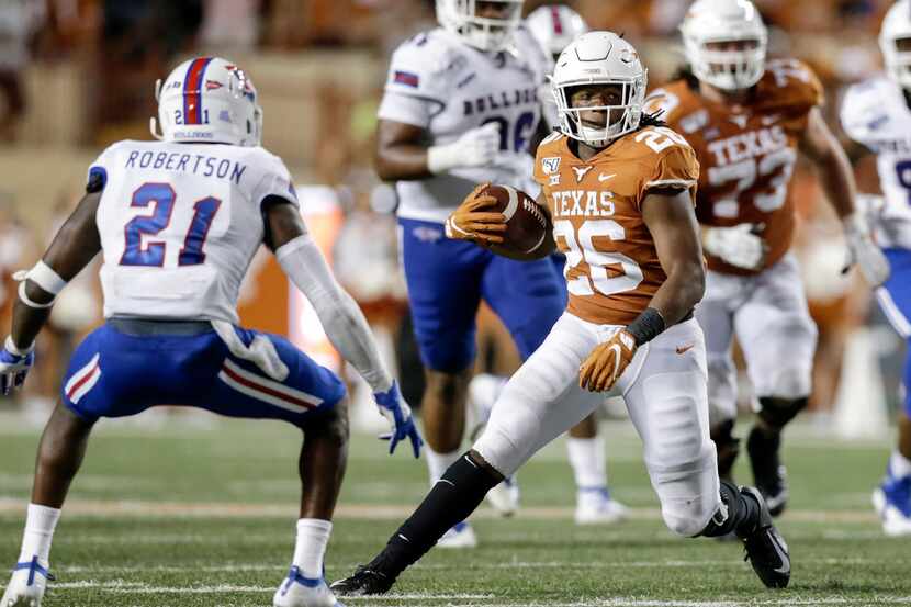 AUSTIN, TX - AUGUST 31:  Keaontay Ingram #26 of the Texas Longhorns runs the ball defended...