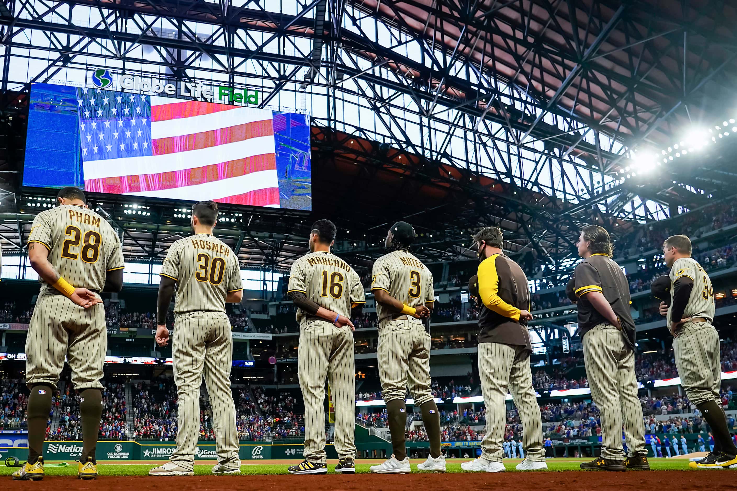 San Diego Padres players stand for the national anthem with the retractable roof closed...