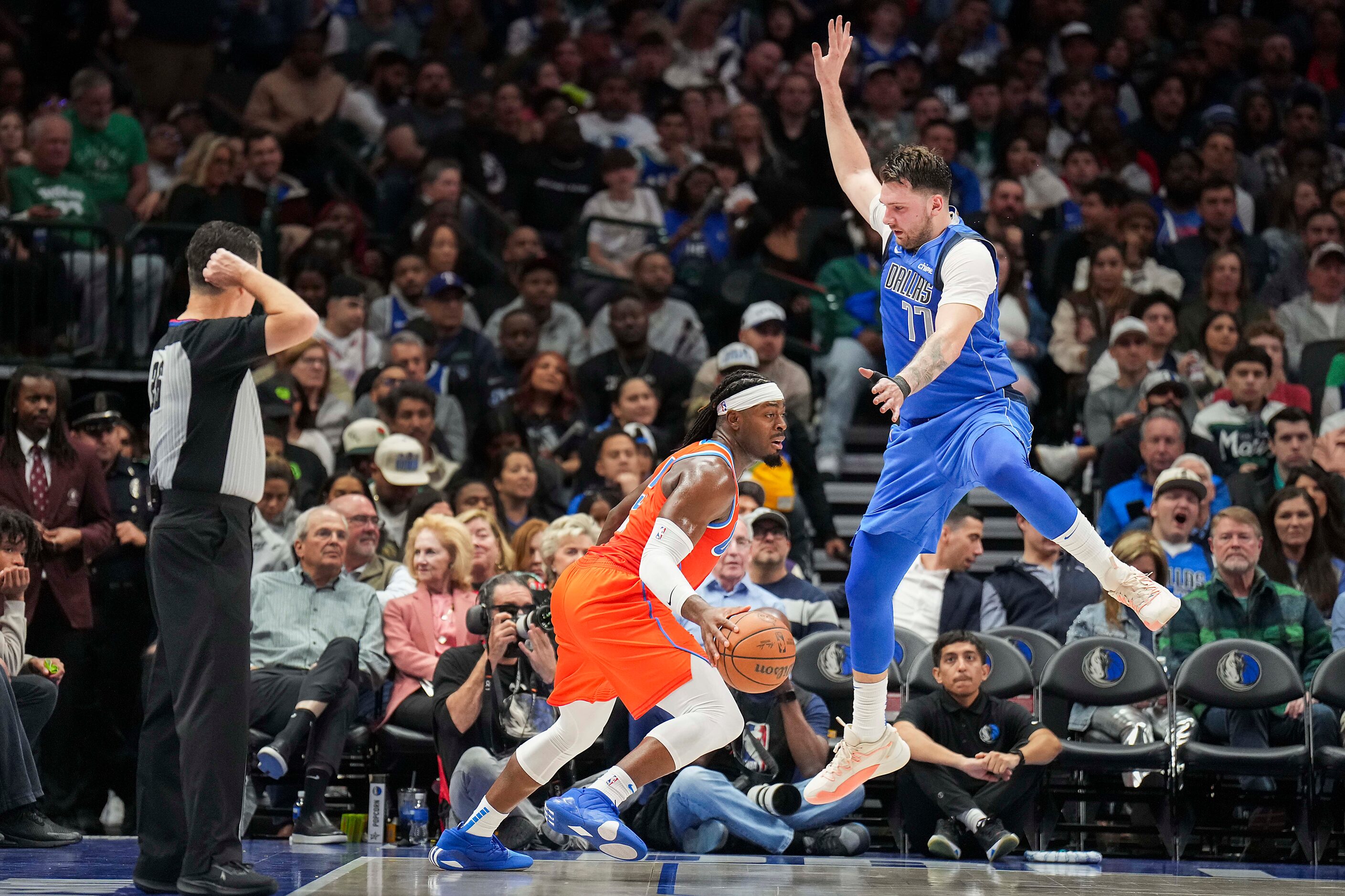 A fake by Oklahoma City Thunder guard Luguentz Dort (5) gets Dallas Mavericks guard Luka...