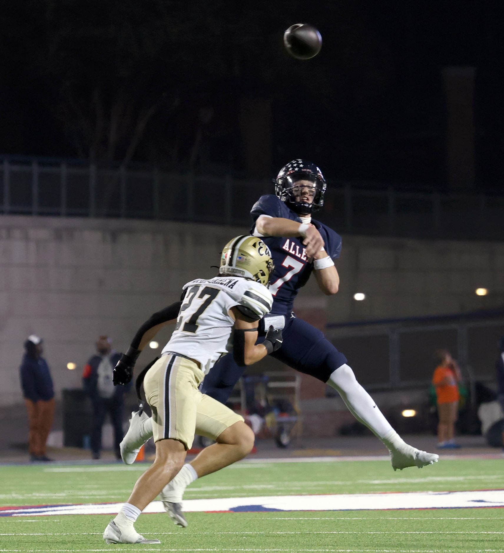 Allen quarterback Brady Bricker (7) launches a long pass downfield as he is defended by...