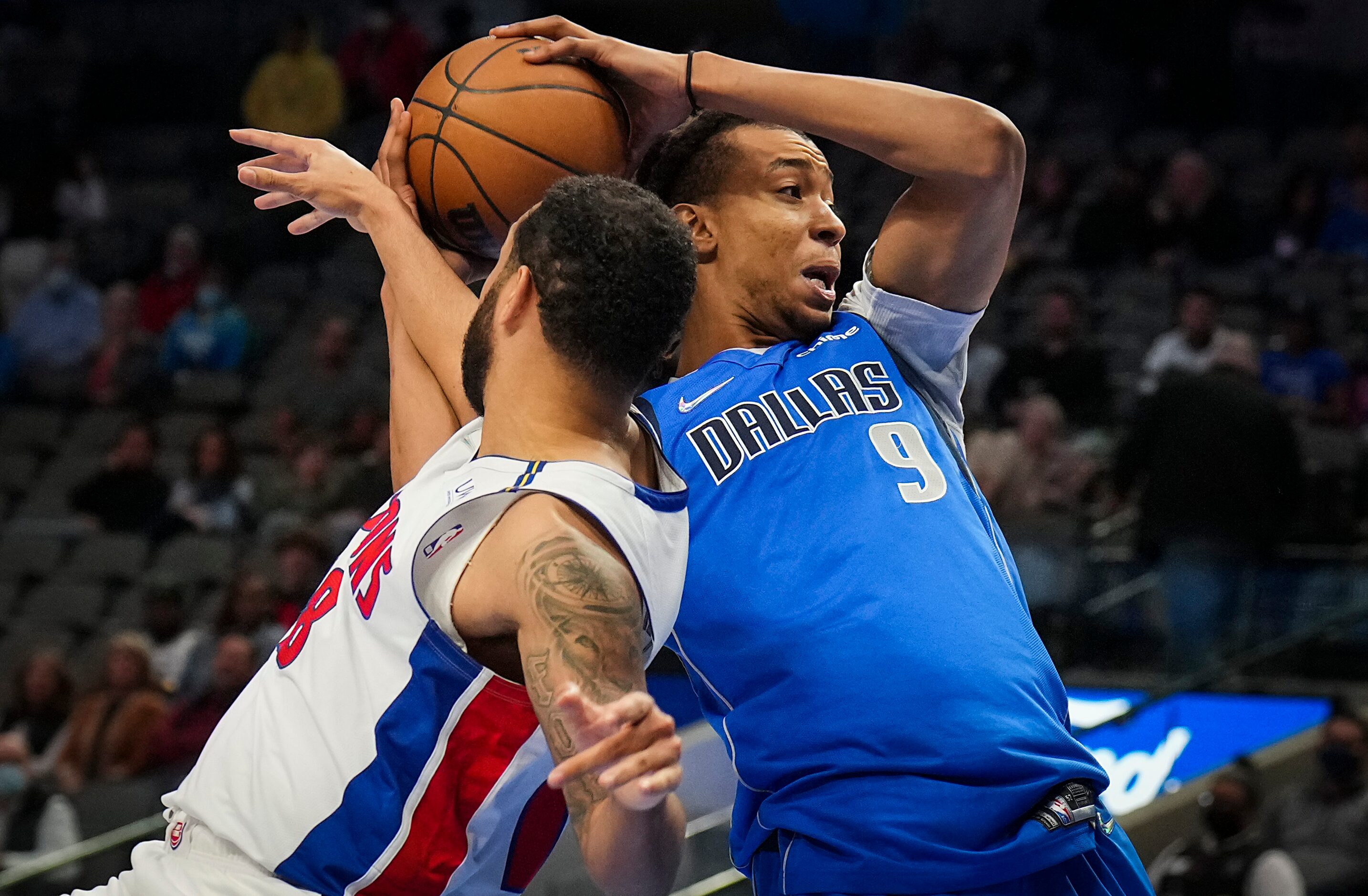 Dallas Mavericks center Moses Brown (9) is fouled by Detroit Pistons forward Trey Lyles (8)...