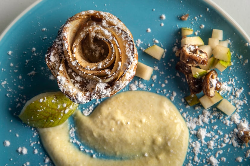 A pear rose tart plated on pear creme anglaise