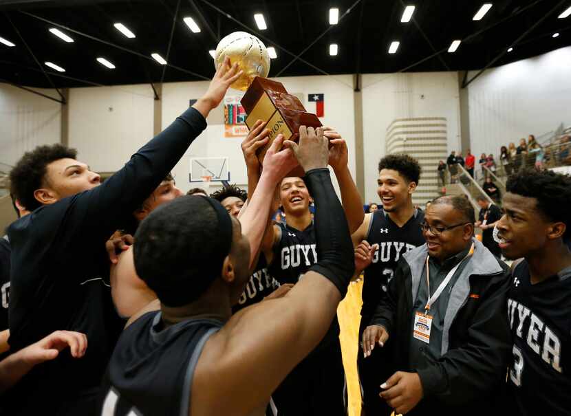 Denton Guyer players hoist a championship trophy after defeating Lakeview Centennial 75-73...