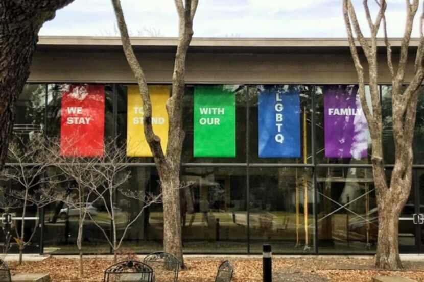 Banners in support of LGBTQ members and friends hang in the windows of Greenland Hills...