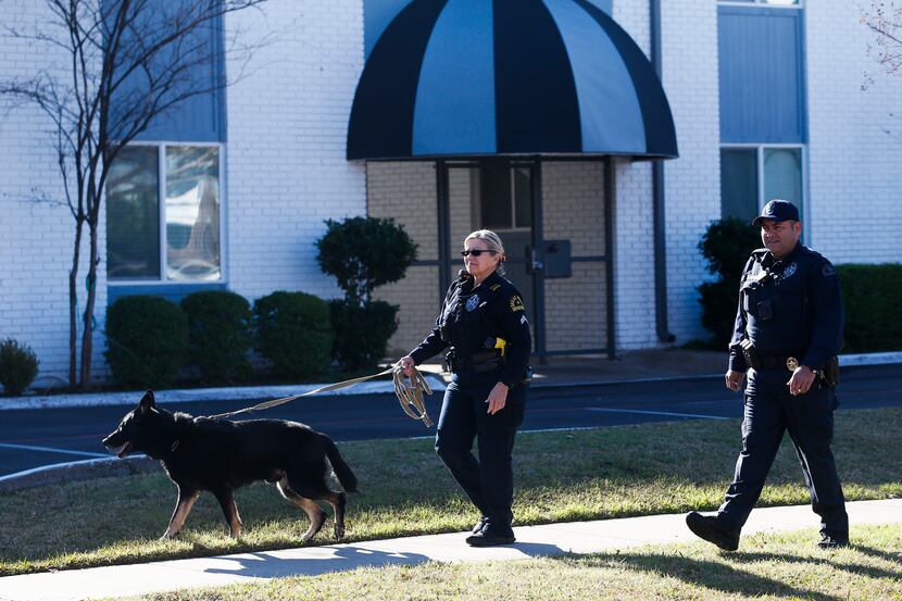 Dallas Police work a crime scene in the 400 block of East Ninth Street in Dallas on...