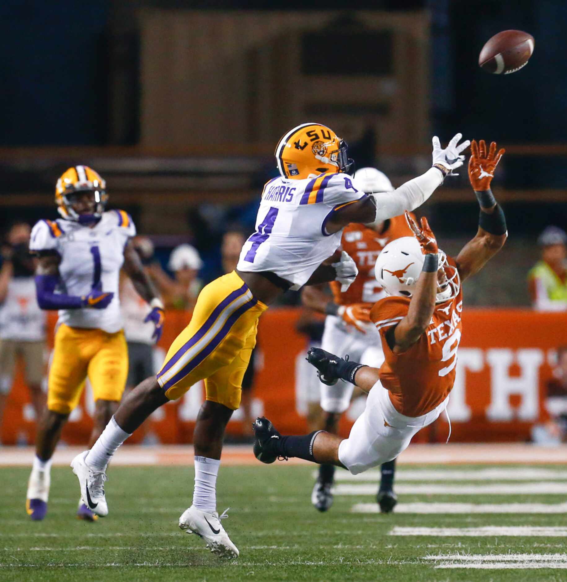 LSU Tigers running back John Emery Jr. (4) breaks up a pass intended for Texas Longhorns...