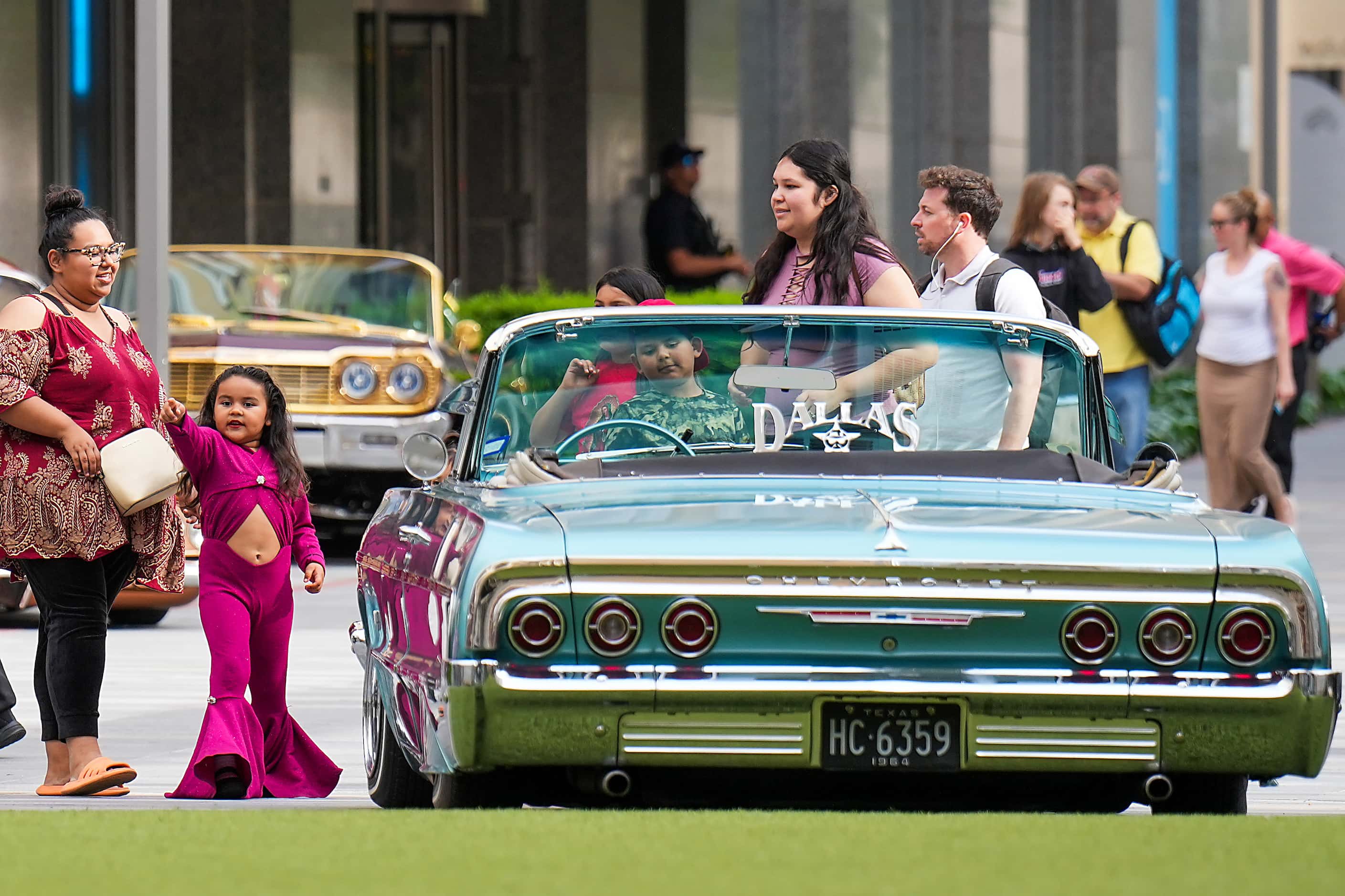 Galilea Huerta, 5, checks out  a display of low riders during a celebration of the life of...